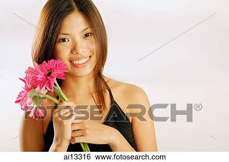 Young woman with bouquet of flowers, smiling at camera View Large Photo Image Stock Photograph - Young woman with bouquet of flowers, smiling at camera. Fotosearch