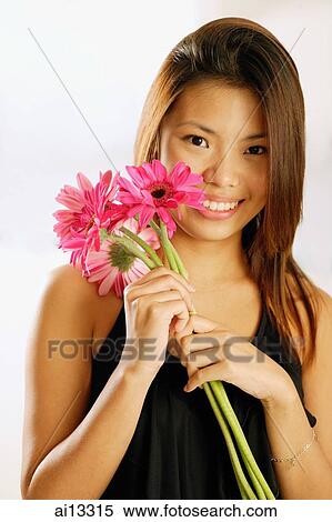 Young woman with bouquet of flowers View Large Photo Image Stock Photography - Young woman with bouquet of flowers. Fotosearch