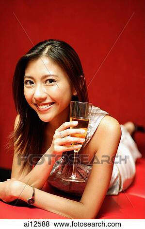 Young woman with champagne glass, smiling at camera View Large Photo Image Stock Photo - Young woman with champagne glass, smiling at camera. Fotosearch