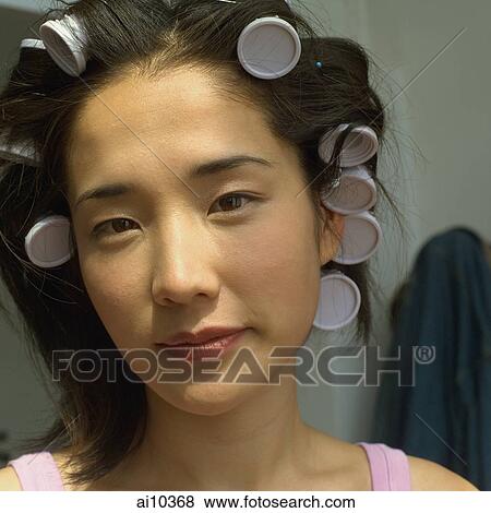 Young woman with curlers in hair, portrait View Large Photo Image Stock Photo - Young woman with curlers in hair, portrait. Fotosearch