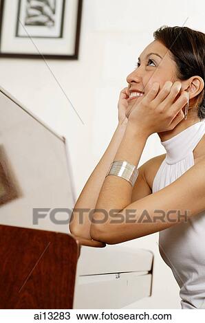 Young woman with hand on chin, looking up View Large Photo Image Stock Image - Young woman with hand on chin, looking up. Fotosearch