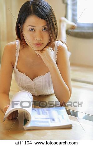Young woman with hands on chin, looking at camera View Large Photo Image Picture - Young woman with hands on chin, looking at camera. Fotosearch