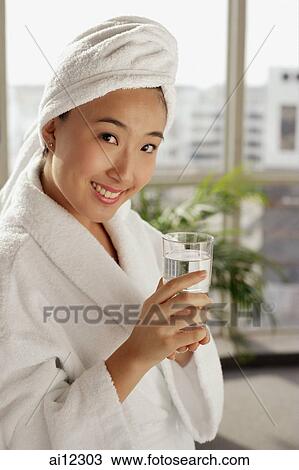 Young woman with make-up brush, looking away View Large Photo Image Stock Image - Young woman with make-up brush, looking away. Fotosearch