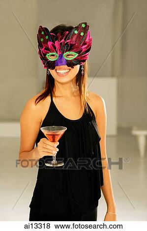 Young woman with mask, holding a drink View Large Photo Image Stock Photo - Young woman with mask, holding a drink. Fotosearch