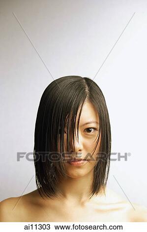 Stock Image - Young woman with wet hair, head shot. Fotosearch