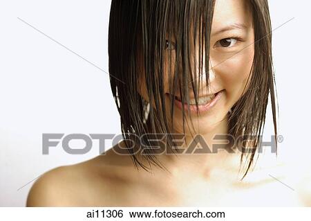 Young woman with wet hair, smiling at camera View Large Photo Image Stock Photograph - Young woman with wet hair, smiling at camera. Fotosearch