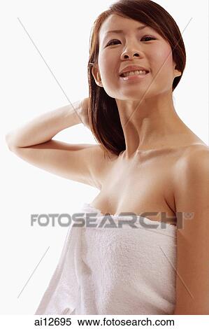 Young woman wrapped in a towel, hand behind head View Large Photo Image Stock Photography - Young woman wrapped in a towel, hand behind head. Fotosearch