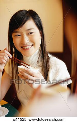 Young women at a Chinese restaurant, eating View Large Photo Image Stock Photography - Young women at a Chinese restaurant, eating. Fotosearch