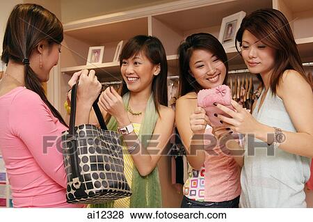 Young women at clothing store, shopping View Large Photo Image Stock Photo - Young women at clothing store, shopping. Fotosearch