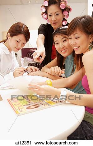 Young women getting manicure at a beauty salon View Large Photo Image Stock Image - Young women getting manicure at a beauty salon. Fotosearch