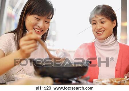Young women having soup at restaurant View Large Photo Image Stock Image - Young women having soup at restaurant. Fotosearch