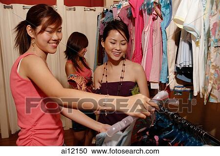 Young women shopping in clothing store View Large Photo Image Stock Image - Young women shopping in clothing store. Fotosearch