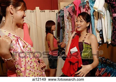 Young women shopping in clothing store View Large Photo Image Stock Photo - Young women shopping in clothing store. Fotosearch
