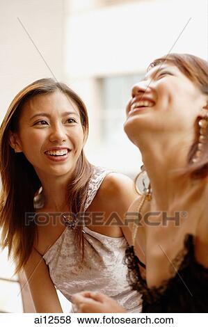 Young women side by side, smiling and laughing View Large Photo Image Stock Photo - Young women side by side, smiling and laughing. Fotosearch