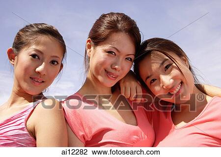 Young women smiling at camera, portrait View Large Photo Image Stock Image - Young women smiling at camera, portrait. Fotosearch