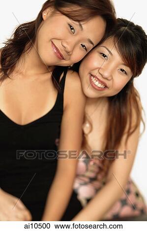 Stock Image - Young women smiling, looking at camera. Fotosearch