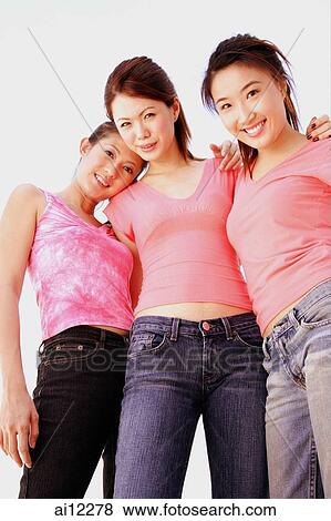 Young women standing, arms around each other View Large Photo Image Stock Photo - Young women standing, arms around each other. Fotosearch