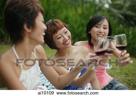 Young women toasting with wine glasses View Large Photo Image Stock Photo - Young women toasting with wine glasses. Fotosearch