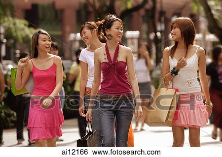 Young women walking and carrying shopping bags View Large Photo Image Stock Photograph - Young women walking and carrying shopping bags. Fotosearch