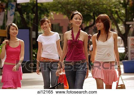 Young women walking and carrying shopping bags View Large Photo Image Stock Photography - Young women walking and carrying shopping bags. Fotosearch