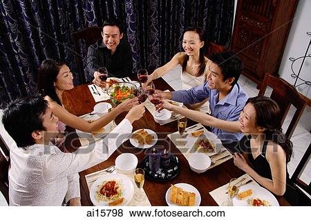 Adults at a dinner party, toasting with drinks View Large Photo Image Stock Photo - Adults at a dinner party, toasting with drinks. Fotosearch