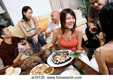 Adults having a party in living room View Large Photo Image Stock Photography - Adults having a party in living room. Fotosearch