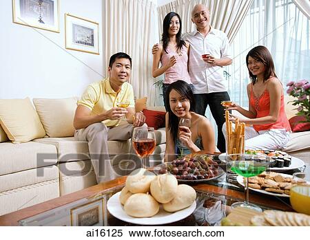 Adults in living room, having a party, smiling at camera View Large Photo Image Stock Photography - Adults in living room, having a party, smiling at camera. Fotosearch