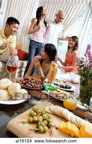 Adults in living room, having party View Large Photo Image Picture - Adults in living room, having party. Fotosearch