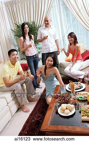 Adults in living room, smiling at camera, social gathering View Large Photo Image Stock Image - Adults in living room, smiling at camera, social gathering. Fotosearch