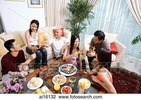 Adults sitting in living room, having a party View Large Photo Image Stock Image - Adults sitting in living room, having a party. Fotosearch