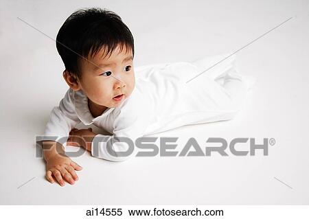 Baby boy lying on front, looking away View Large Photo Image Stock Photography - Baby boy lying on front, looking away. Fotosearch