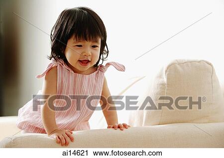 Baby girl on sofa, smiling View Large Photo Image Stock Image - Baby girl on sofa, smiling. Fotosearch