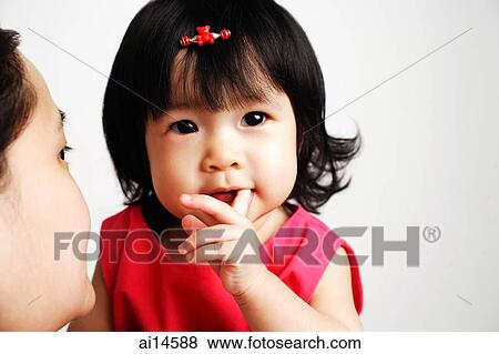 Baby girl with finger in mouth, mother carrying her View Large Photo Image Stock Photo - Baby girl with finger in mouth, mother carrying her. Fotosearch