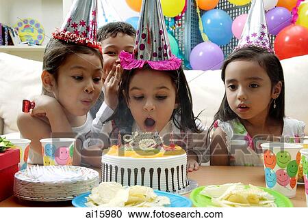Birthday party, young girl blowing candles on cake View Large Photo Image Stock Image - Birthday party, young girl blowing candles on cake. Fotosearch