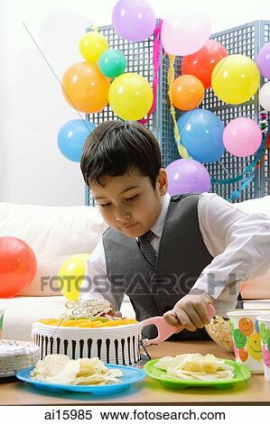 Boy cutting birthday cake View Large Photo Image Stock Photography - Boy cutting birthday cake. Fotosearch