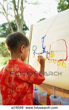 Boy drawing on easel, over the shoulder view View Large Photo Image Stock Photograph - Boy drawing on easel, over the shoulder view. Fotosearch