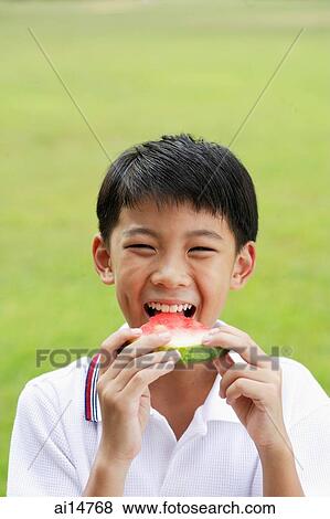Stock Photo - Boy eating slice of watermelon. Fotosearch