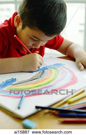 Boy holding colour pencil, drawing a rainbow View Large Photo Image Stock Photo - Boy holding colour pencil, drawing a rainbow. Fotosearch