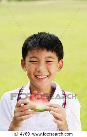 Boy holding slice of watermelon View Large Photo Image Stock Photo - Boy holding slice of watermelon. Fotosearch
