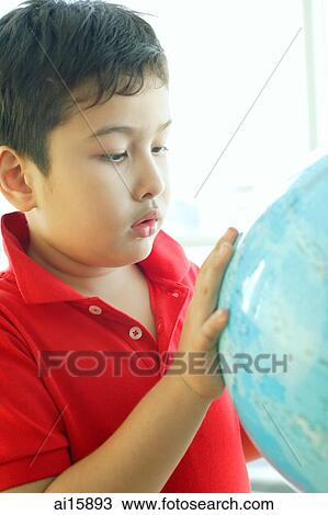 Stock Image - Boy looking at globe. Fotosearch