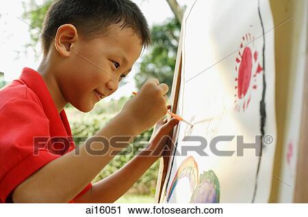 Boy painting on easel View Large Photo Image Stock Image - Boy painting on easel. Fotosearch