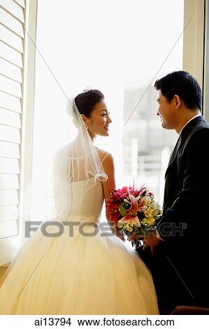Bride and groom at window, looking at each other View Large Photo Image Picture - Bride and groom at window, looking at each other. Fotosearch