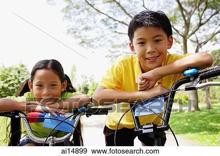 Brother and sister on bicycles, looking at camera View Large Photo Image Stock Photo - Brother and sister on bicycles, looking at camera. Fotosearch