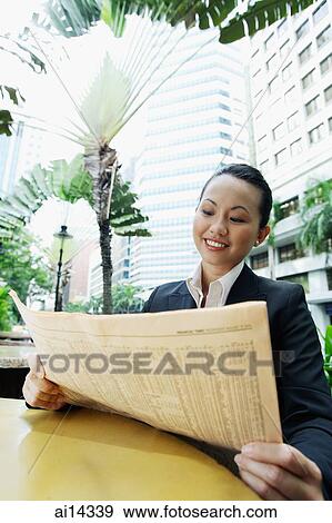 Stock Photo - Business woman holding newspaper. Fotosearch