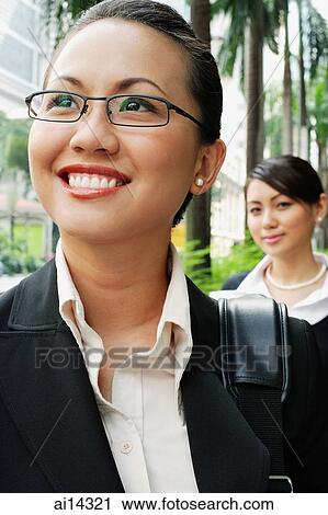Business woman, smiling, looking away, people in the background View Large Photo Image Stock Image - Business woman, smiling, looking away, people in the background. Fotosearch