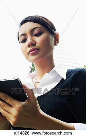 Business woman using PDA View Large Photo Image Stock Photograph - Business woman using PDA. Fotosearch