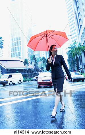 Business woman with umbrella, crossing the road View Large Photo Image Picture - Business woman with umbrella, crossing the road. Fotosearch