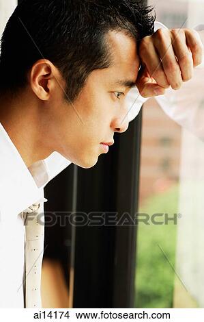 Businessman leaning on window pane, looking out View Large Photo Image Picture - Businessman leaning on window pane, looking out. Fotosearch