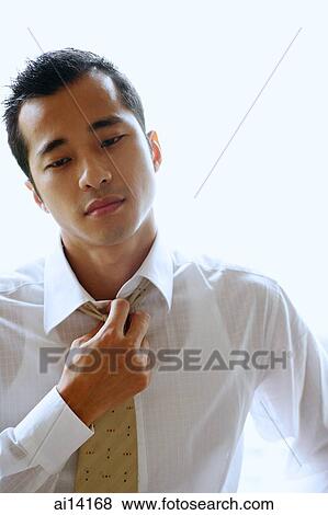 Stock Photo - Businessman loosening tie. Fotosearch