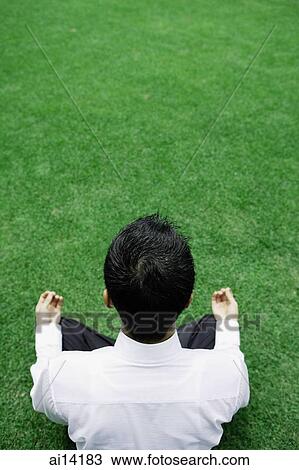 Businessman sitting on grass, directly above View Large Photo Image Stock Image - Businessman sitting on grass, directly above. Fotosearch